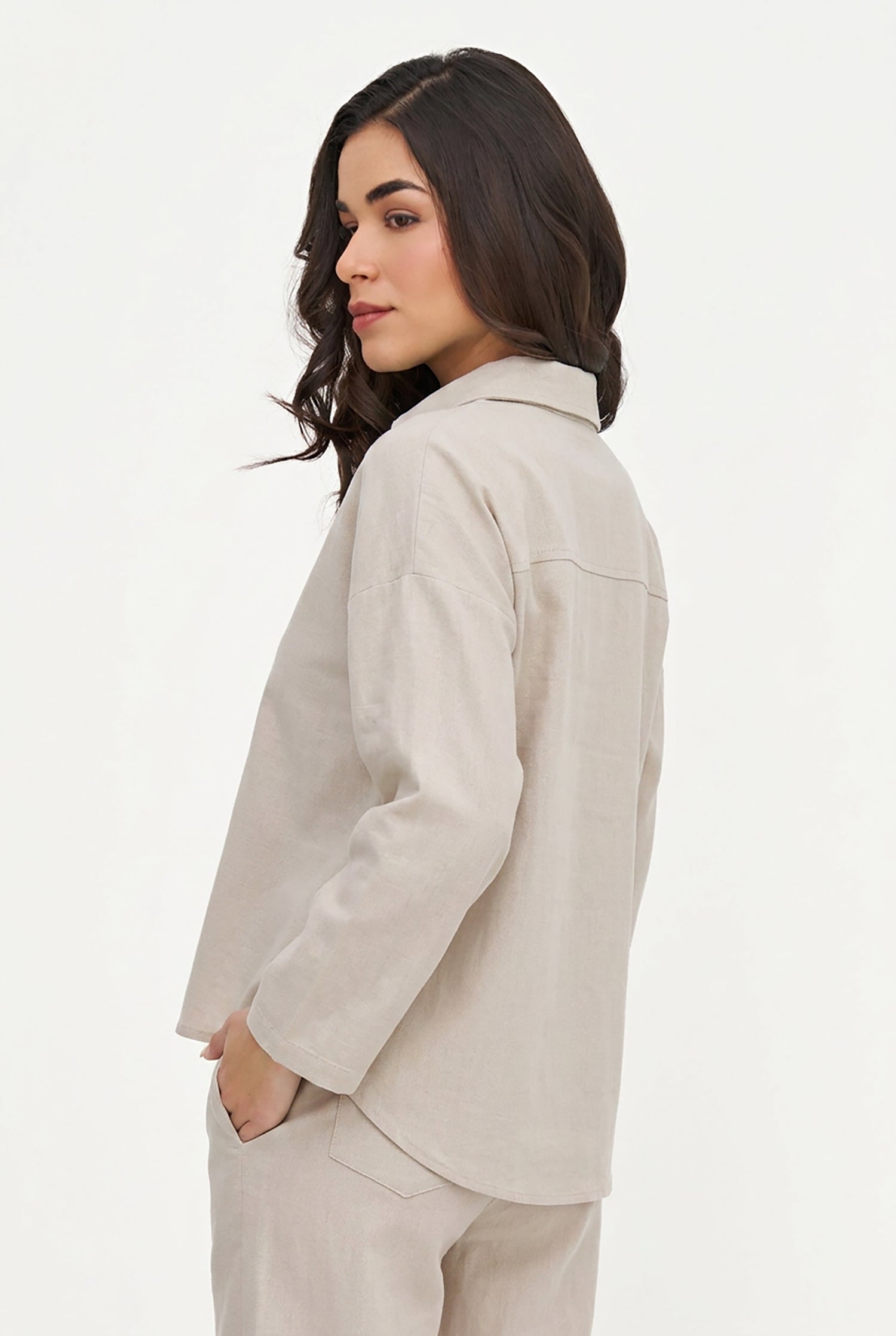Woman wearing a beige suit on a white background