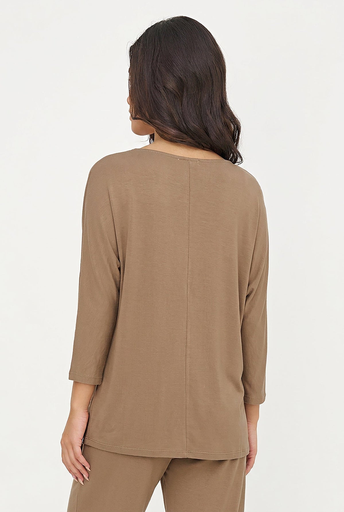 A woman shown from the back wearing a taupe brown three-quarter sleeve top and matching pants against a plain white studio background.