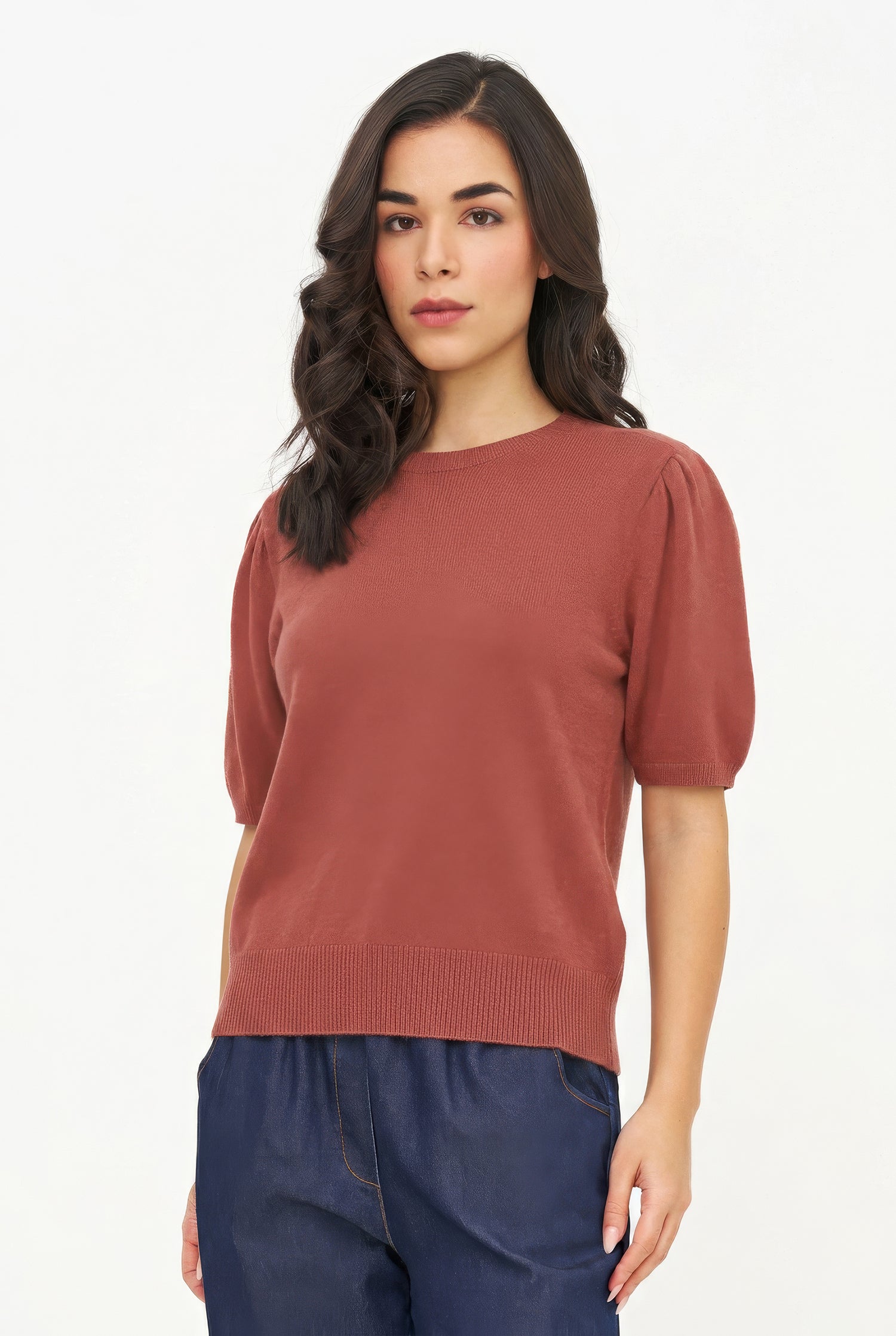 Woman wearing a rust-colored sweater with short sleeves on a white background