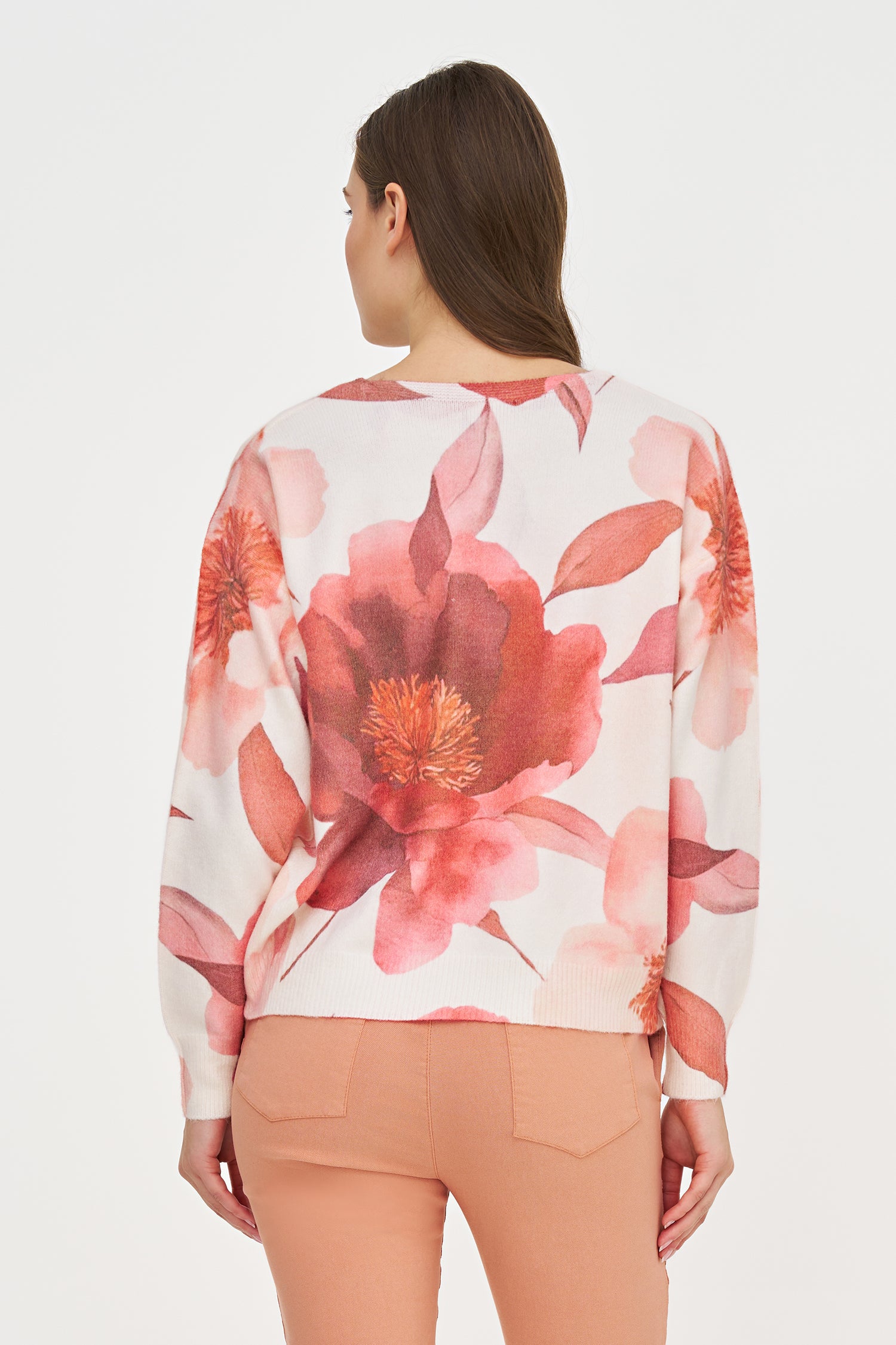 Woman wearing a floral blouse with a white background