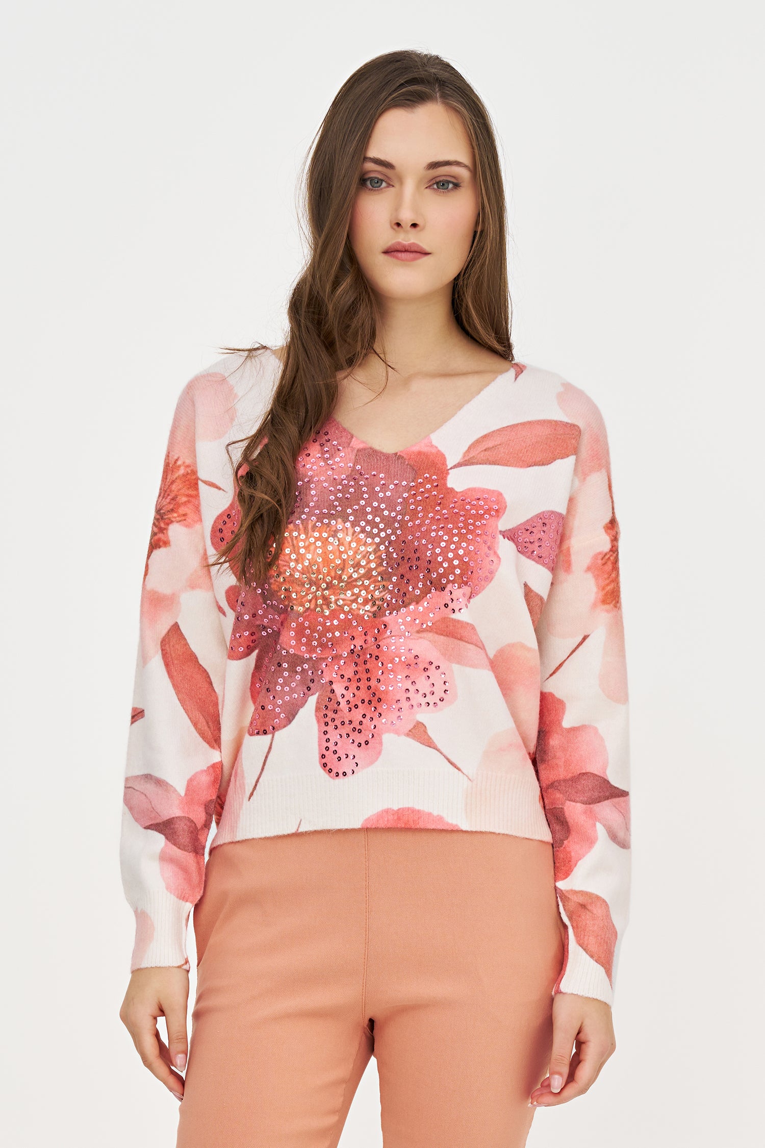 Woman wearing a floral blouse with a plain background