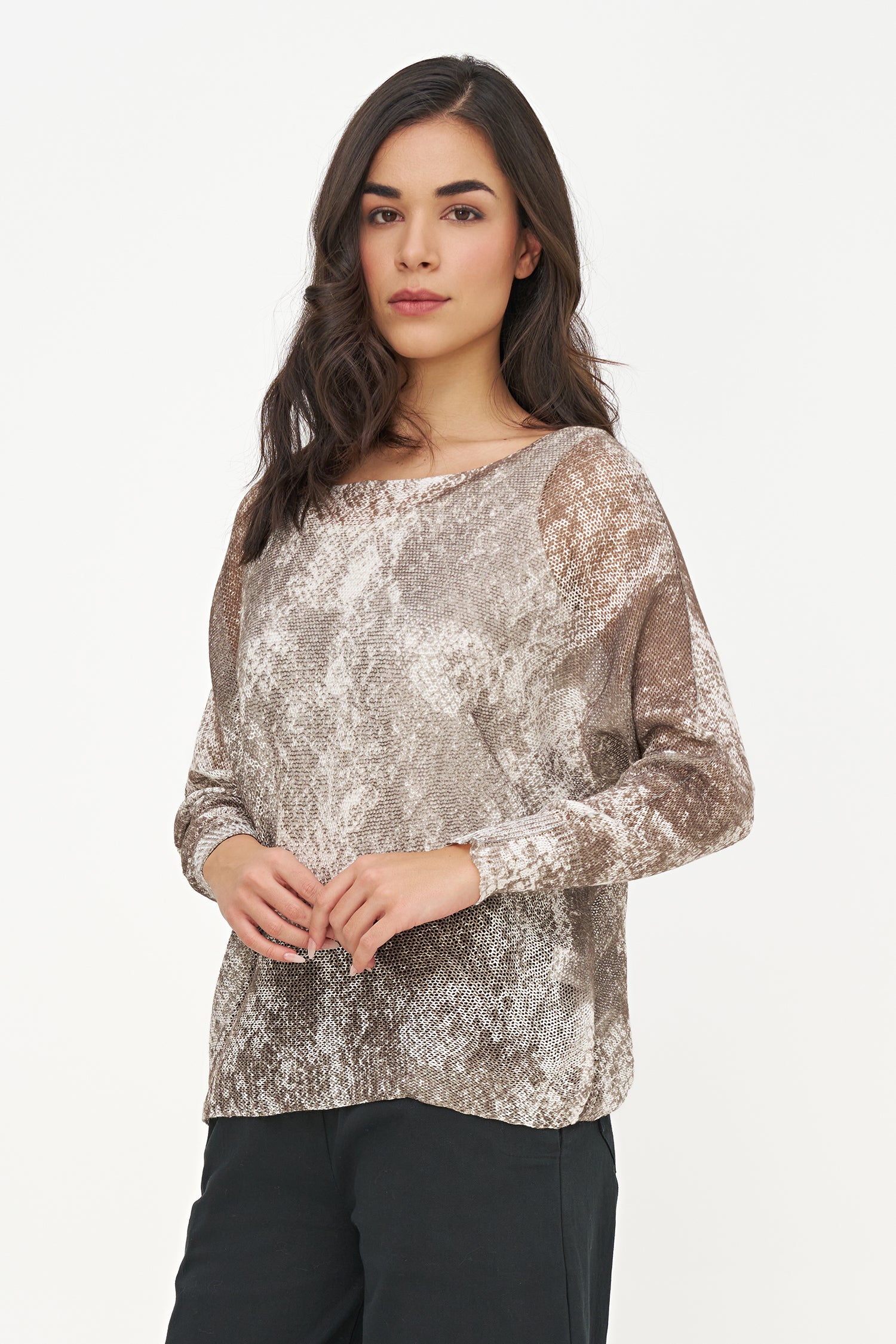 Woman wearing a patterned top on a white background