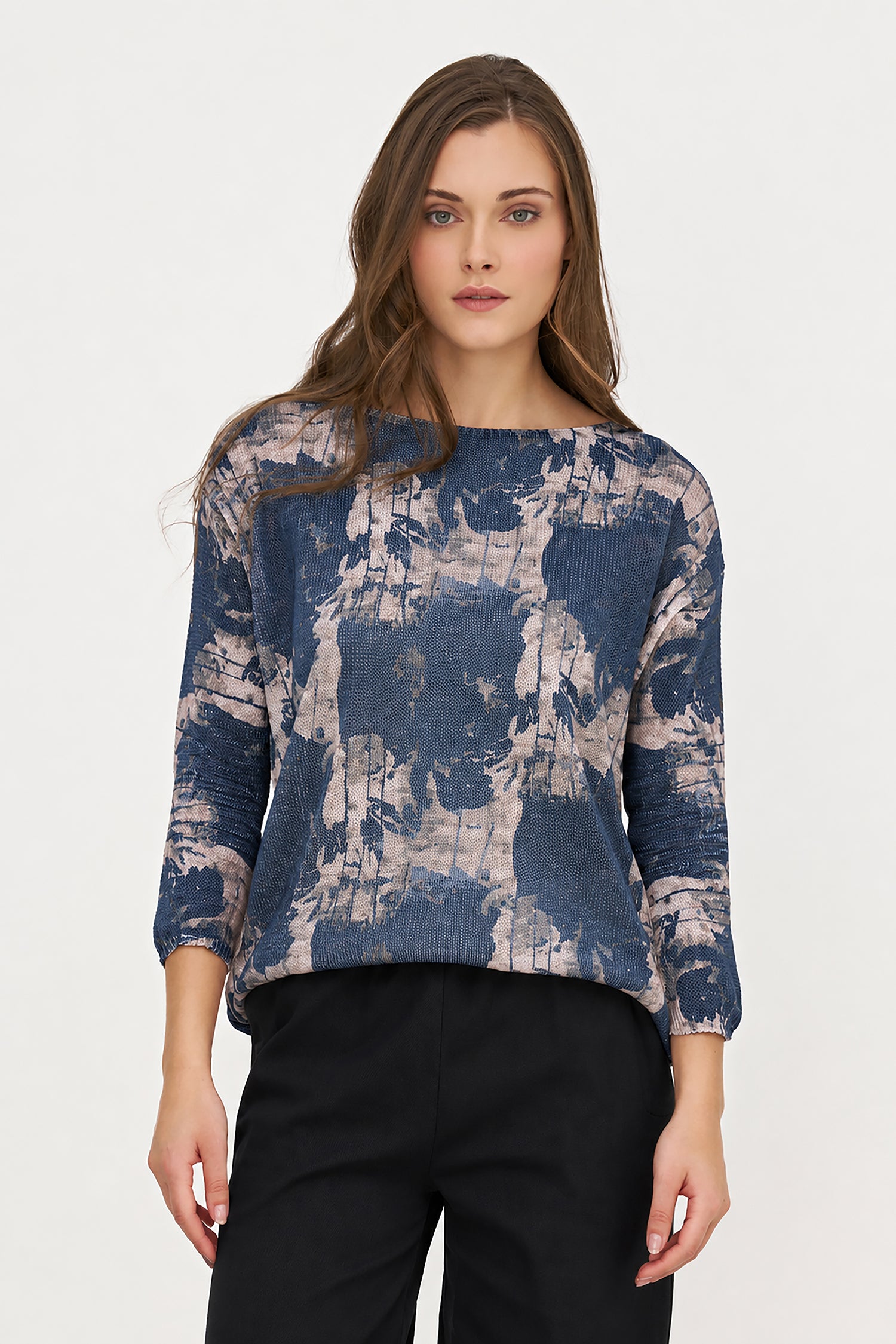 Woman wearing a blue and gray patterned top on a white background