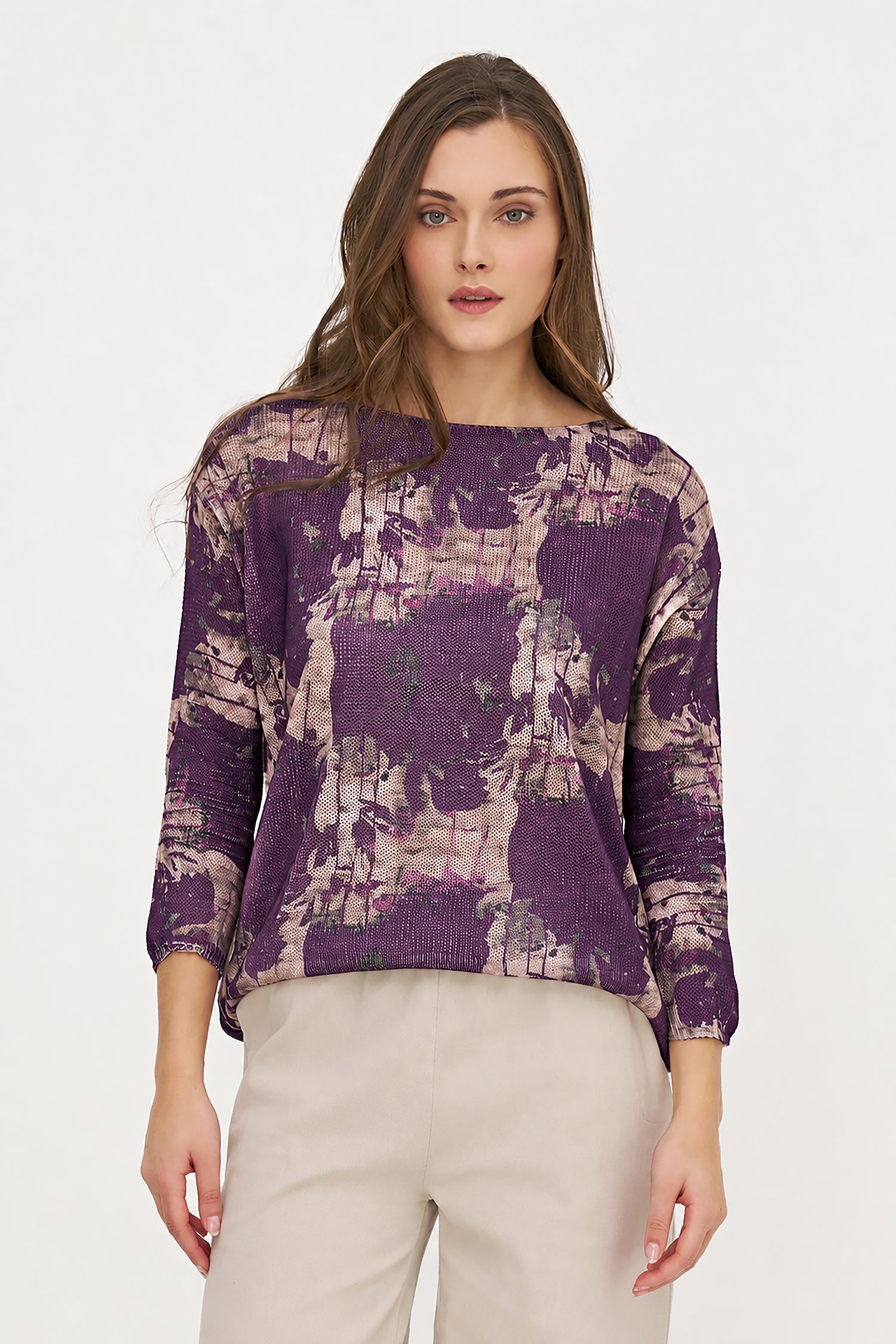 Woman wearing a purple patterned sweater on a white background