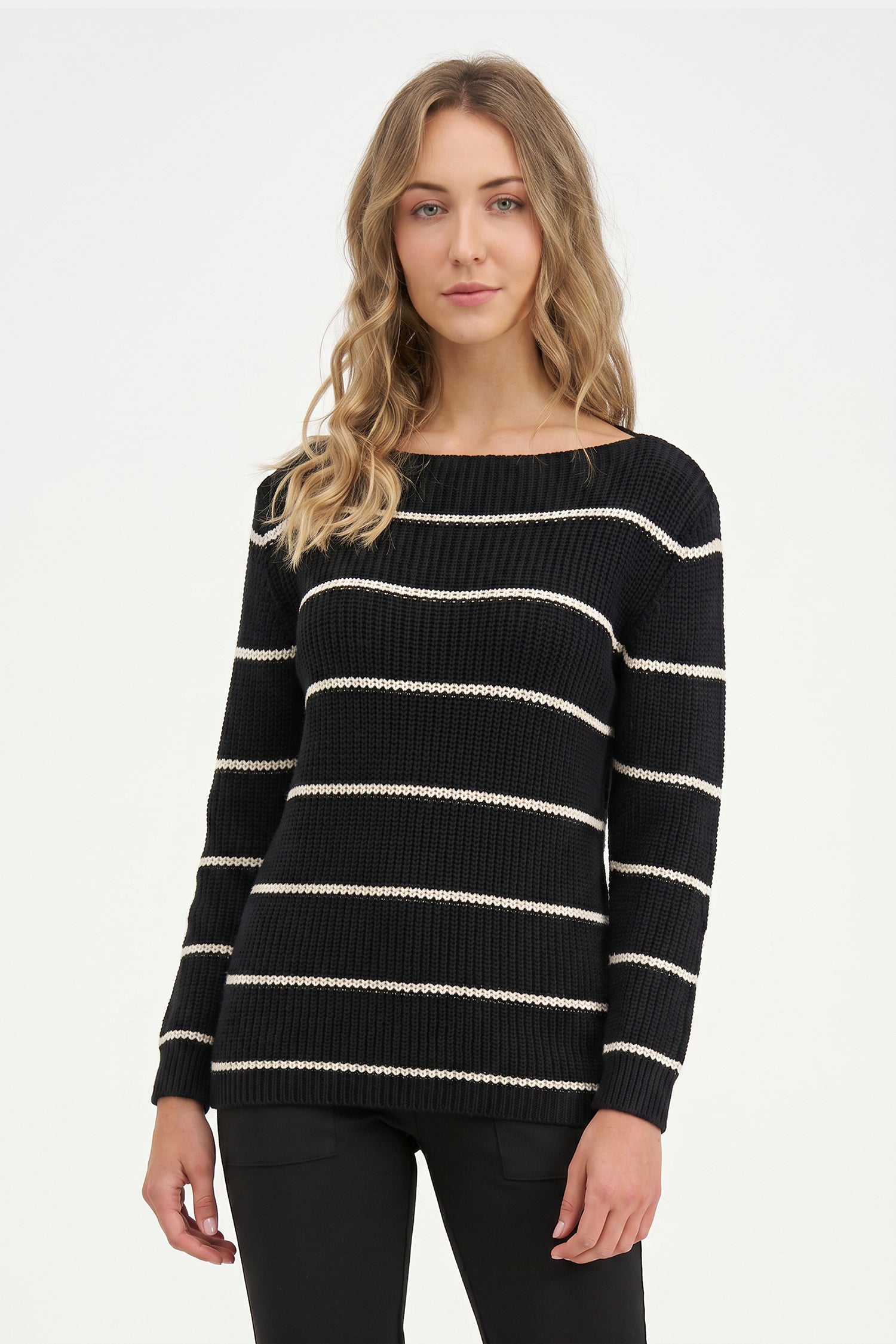Woman wearing a black and white striped sweater on a white background
