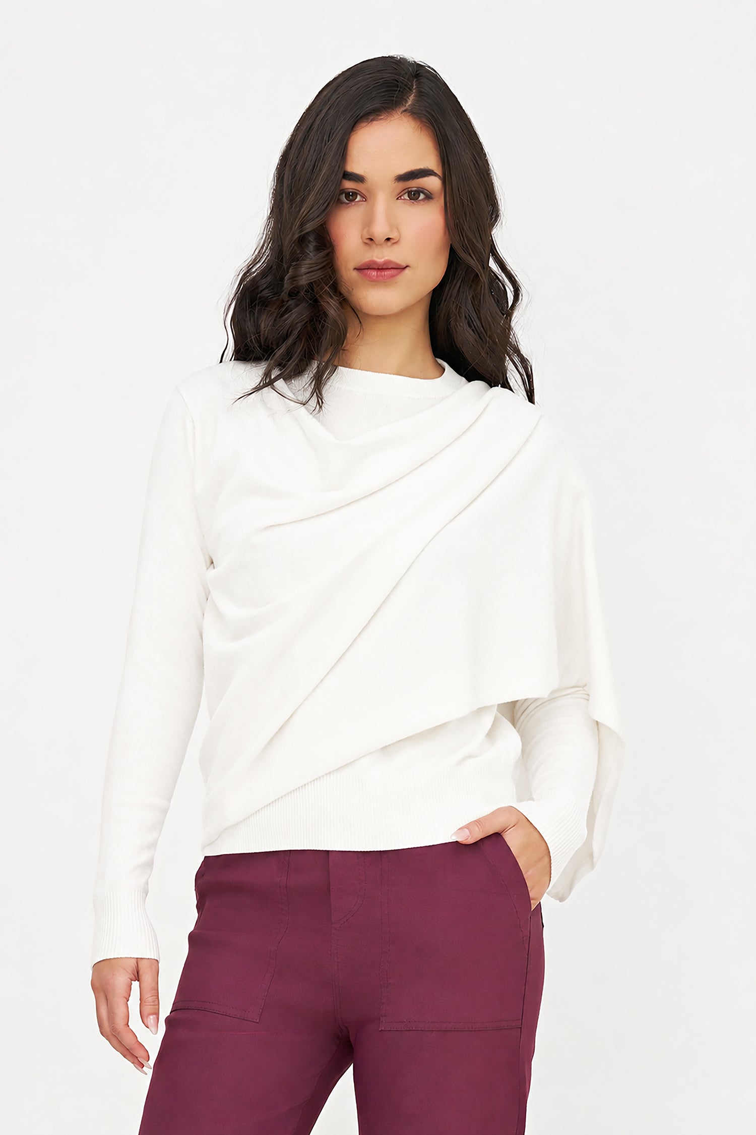 Woman wearing a white top and maroon pants on a white background