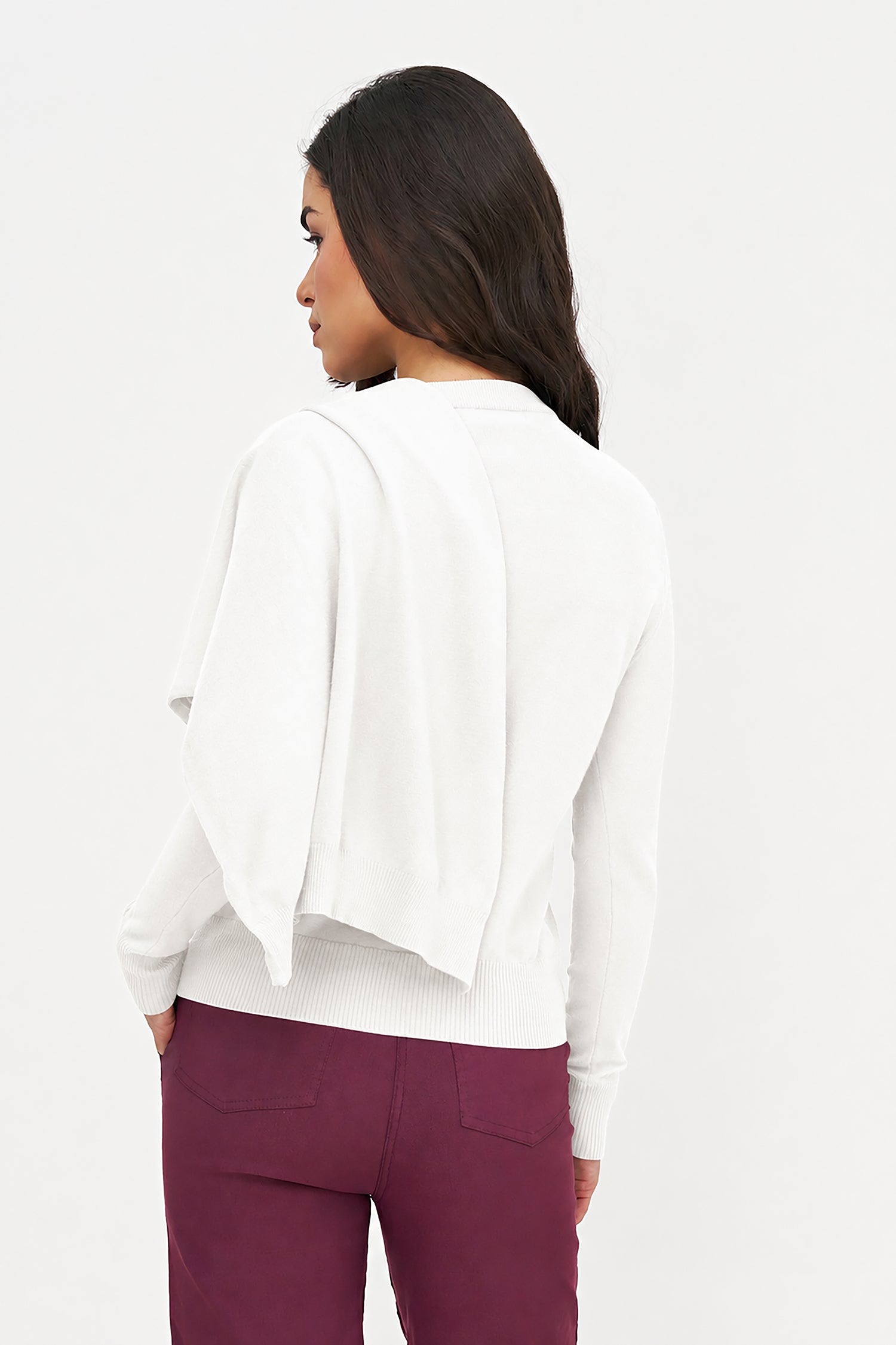 Person wearing a white jacket and burgundy pants on a white background