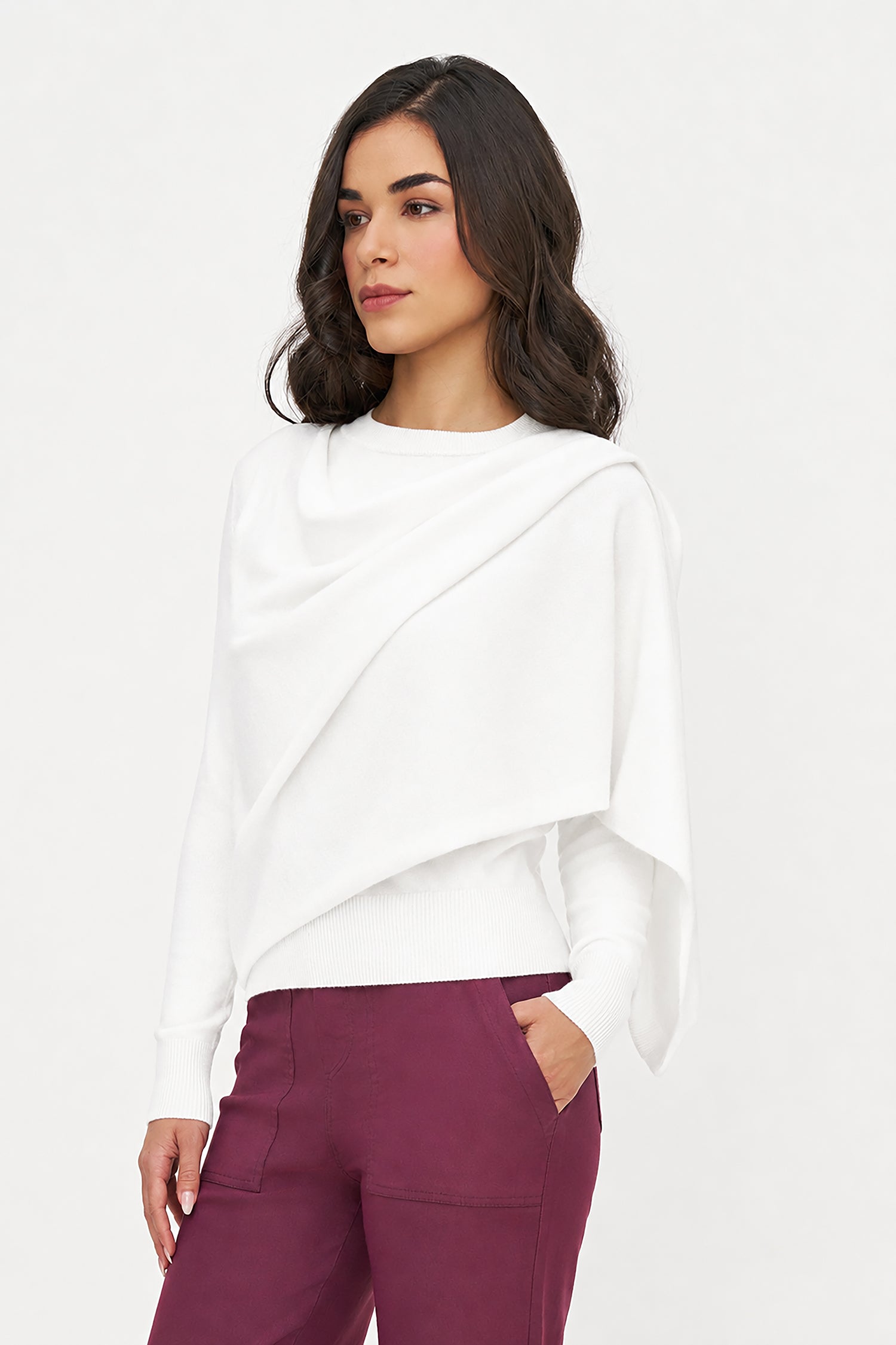 Woman wearing a white top and purple pants on a white background